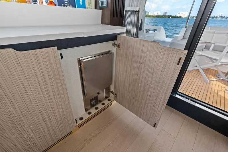 Slide: The Image of Open cabinet on 2019 Azimut yacht with ocean view and deck seating. - 16