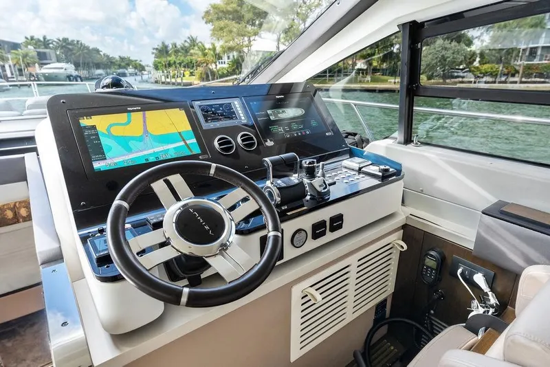 Slide: The Image of 2019 Azimut yacht helm with advanced navigation displays and steering wheel. - 25