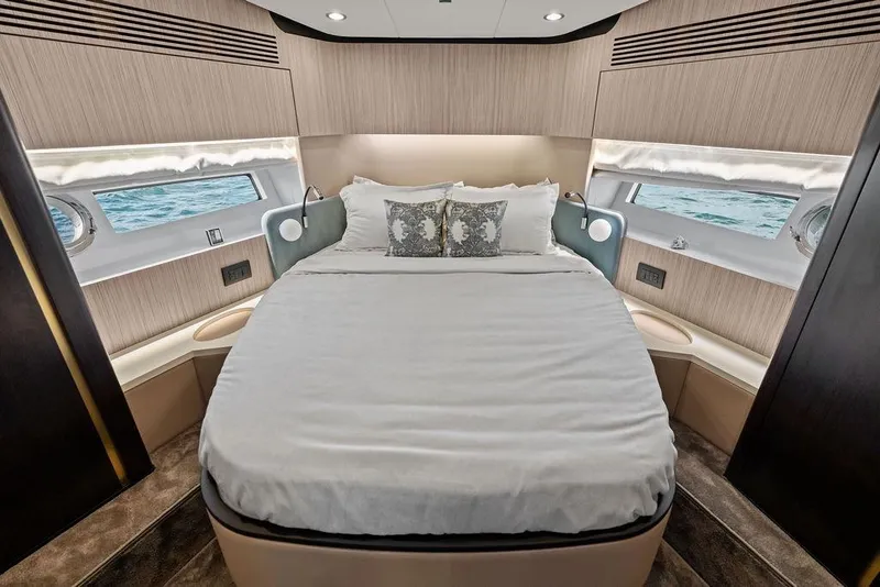 Slide: The Image of Luxurious 2019 Azimut yacht bedroom with ocean view, elegant bedding, and modern design. - 35