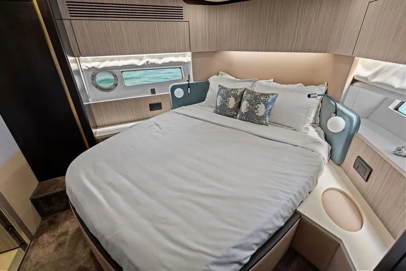 Slide: The Image of Luxurious 2019 Azimut yacht bedroom with elegant bedding and ocean view. - 36
