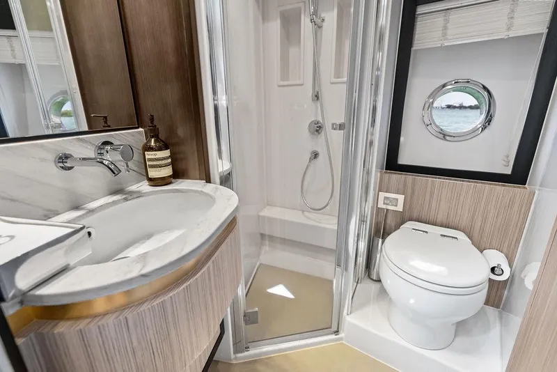 Slide: The Image of Luxurious 2019 Azimut yacht bathroom with modern fixtures and porthole window. - 38