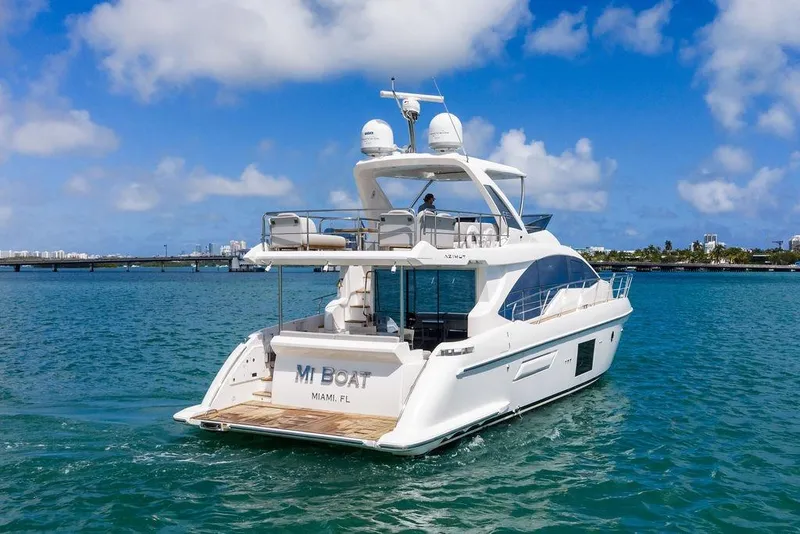 Slide: The Image of Luxurious 2019 Azimut yacht cruising in Miami waters under a clear blue sky. - 4