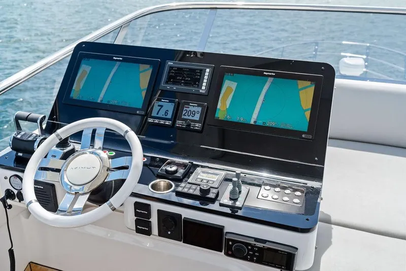 Slide: The Image of 2019 Azimut yacht helm with dual navigation screens and steering wheel. - 46