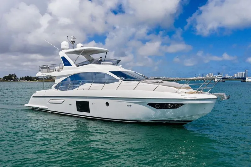 Slide: The Image of Luxurious 2019 Azimut yacht cruising on clear blue waters under a partly cloudy sky. - 5