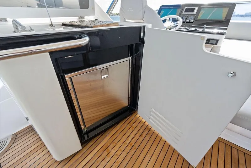 Slide: The Image of 2019 Azimut yacht interior with open cabinet and sleek wooden flooring. - 54