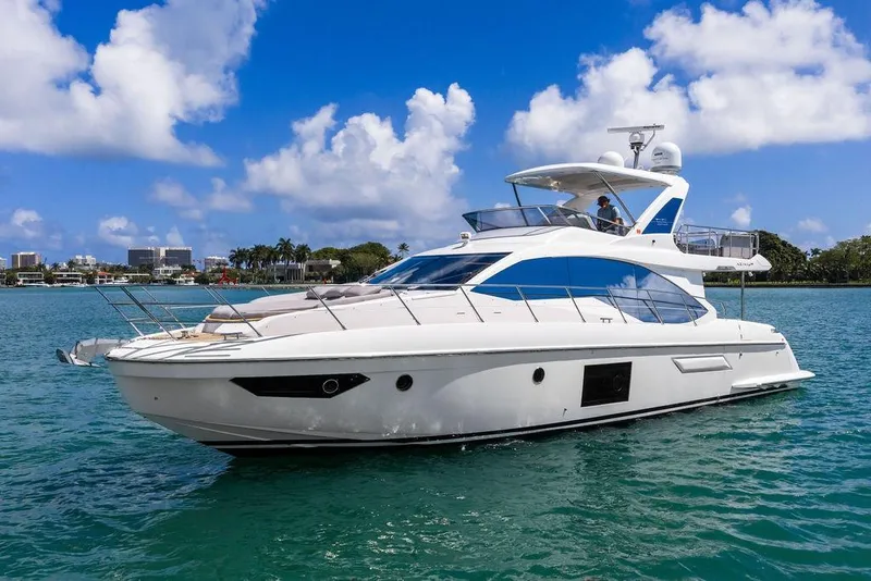 Slide: The Image of Luxurious 2019 Azimut yacht cruising on clear blue waters under a bright sky. - 6