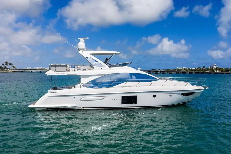 Slide: The Image of 2019 Azimut yacht cruising on clear blue waters under a sunny sky. - 7