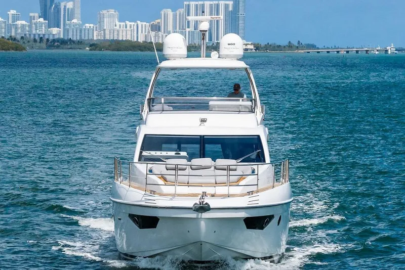 Slide: The Image of Luxurious 2019 Azimut yacht cruising near a city skyline on a sunny day. - 9