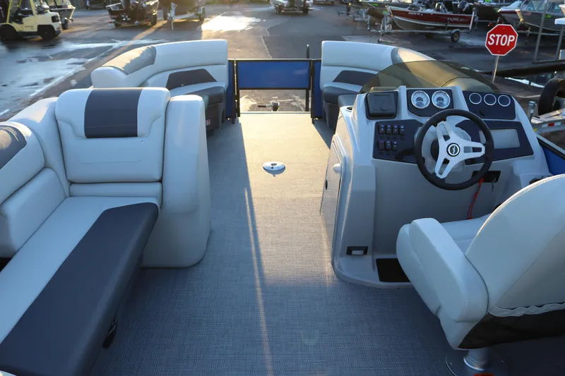 Slide: The Image of 2026 SunChaser Geneva Fish 22 pontoon boat interior with plush seating and modern helm. - 10