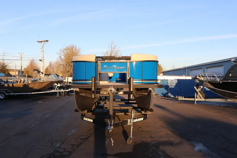 Slide: The Image of 2026 SunChaser Geneva Fish 22 pontoon boat on trailer in outdoor lot. - 3