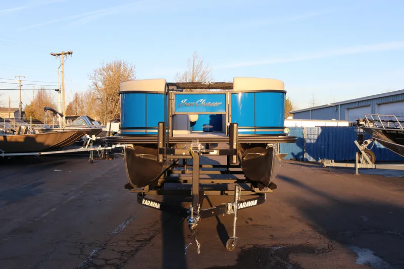 Slide: The Image of 2026 SunChaser Geneva Fish 22 pontoon boat on trailer, parked outdoors. - 4