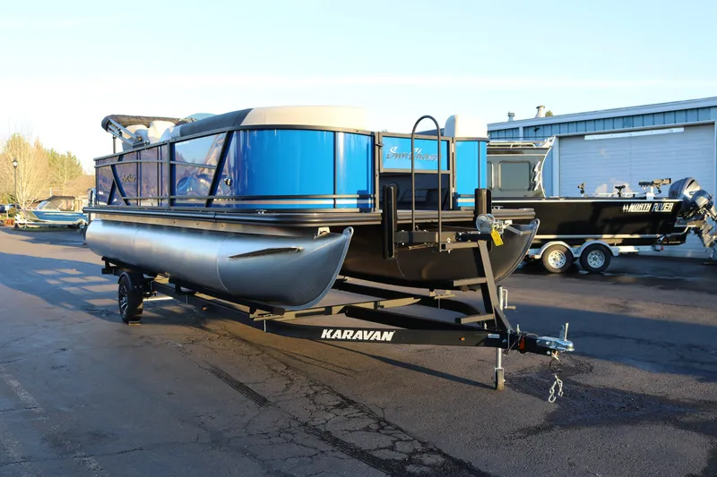 Slide: The Image of 2026 SunChaser Geneva Fish 22 pontoon boat on Karavan trailer in parking lot. - 5