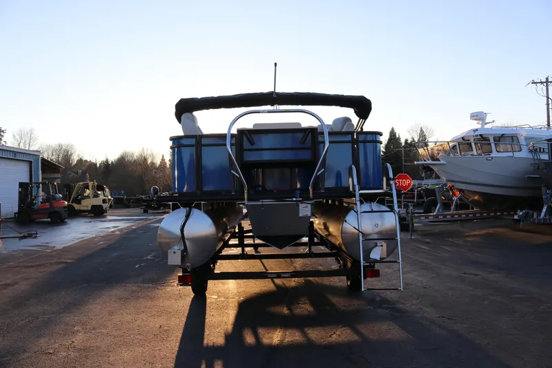 Slide: The Image of 2026 SunChaser Geneva Fish 22 pontoon boat on trailer at marina. - 8