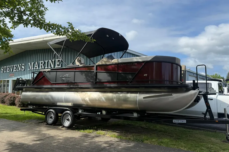 The Image of 2026 SunChaser Eclipse 23 SB DH pontoon boat on trailer, parked outdoors. - 0