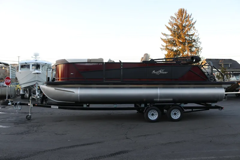 The Image of 2026 SunChaser Eclipse 23 SB DH pontoon boat on trailer, parked outdoors. - 1