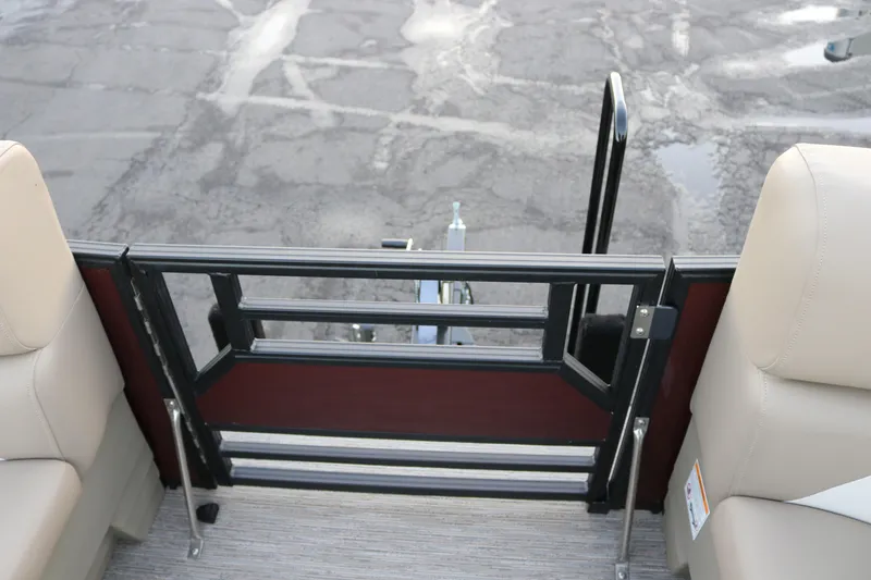 Slide: The Image of SunChaser Eclipse 23 SB DH 2026 boat interior with beige seating and safety gate. - 19