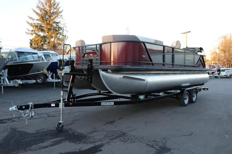 Slide: The Image of 2026 SunChaser Eclipse 23 SB DH pontoon boat on trailer in parking lot. - 2