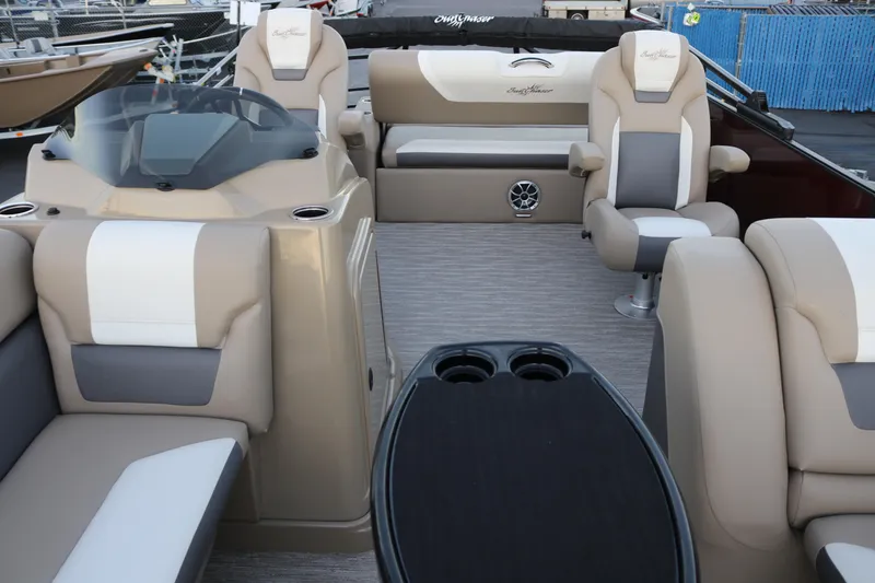 Slide: The Image of 2026 SunChaser Eclipse 23 SB DH boat interior with beige seating and modern dashboard. - 24