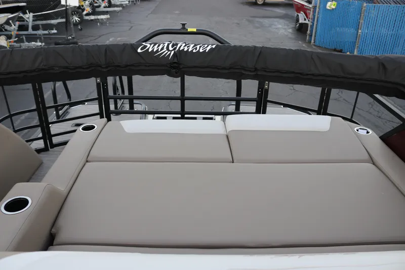 Slide: The Image of 2026 SunChaser Eclipse 23 SB DH boat with cushioned seating and cup holders. - 31