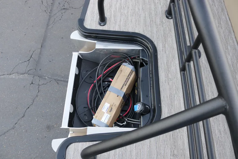 Slide: The Image of Storage compartment of 2026 SunChaser Eclipse 23 SB DH with cables and a cardboard box. - 36