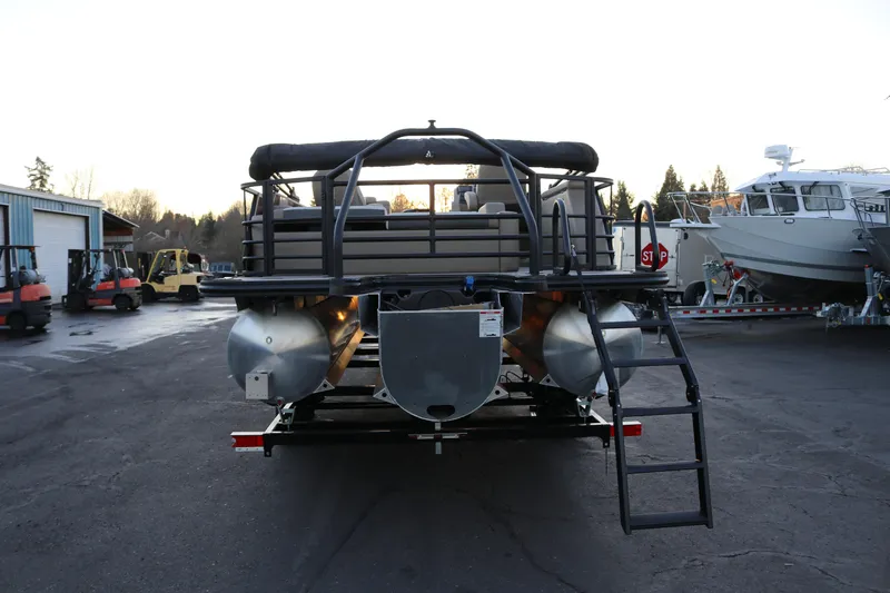 Slide: The Image of 2026 SunChaser Eclipse 23 SB DH pontoon boat, rear view with ladder, parked outdoors. - 7
