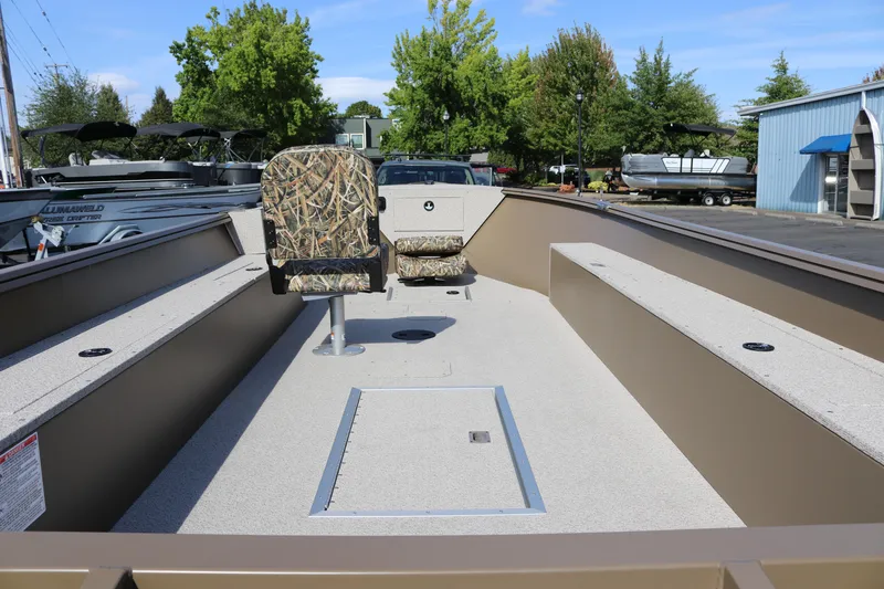 Slide: The Image of 2026 Smoker Craft Freedom 180 TL boat with camo seats, spacious deck, and storage compartments. - 10