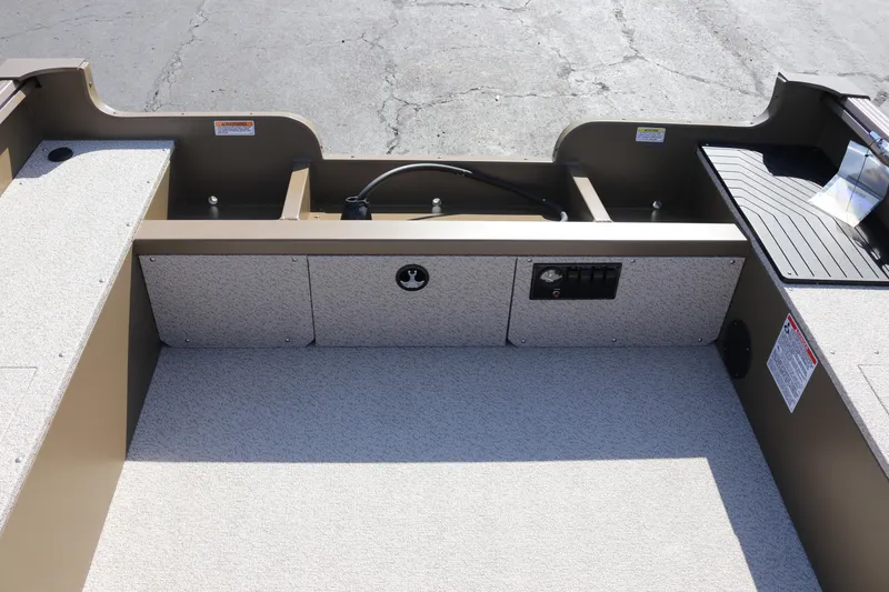 Slide: The Image of Interior view of 2026 Smoker Craft Freedom 180 TL boat, showcasing seating and storage areas. - 2