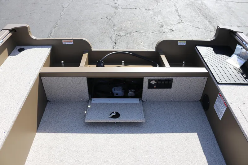 Slide: The Image of 2026 Smoker Craft Freedom 180 TL boat interior with storage compartments and control panel. - 3