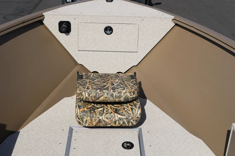 Slide: The Image of 2026 Smoker Craft Freedom 180 TL boat interior with camouflage seating and storage compartment. - 5