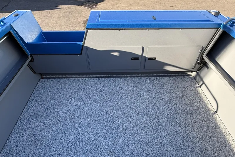 Slide: The Image of 2026 Alumaweld Intruder Outboard 22 boat interior with spacious, textured flooring and storage compartments. - 19