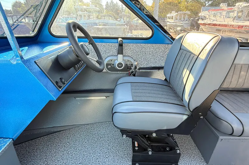 Slide: The Image of 2026 Alumaweld Intruder Outboard 22 boat storage compartment with blue lid open. - 24