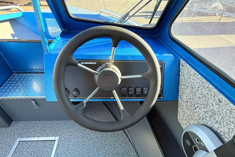 Slide: The Image of 2026 Alumaweld Intruder Outboard 22 interior with textured flooring and storage compartment. - 28