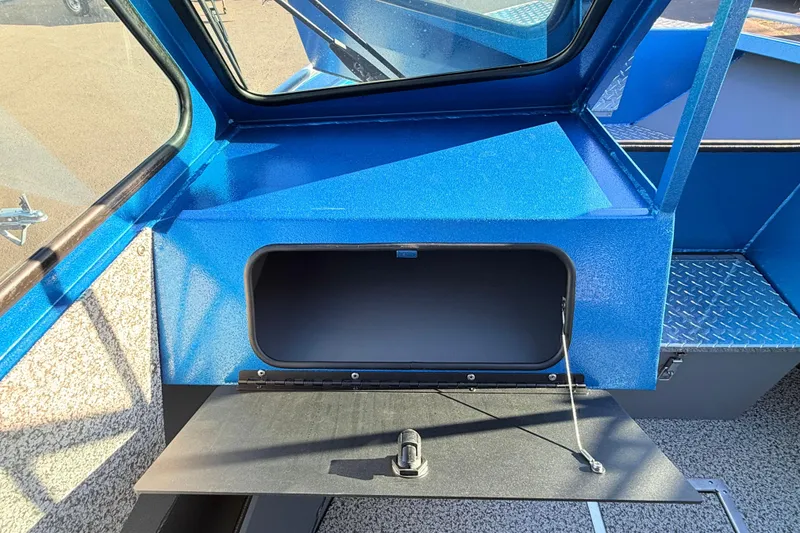 Slide: The Image of Alumaweld Intruder Outboard 22, 2026 model, featuring a diamond plate storage compartment. - 30