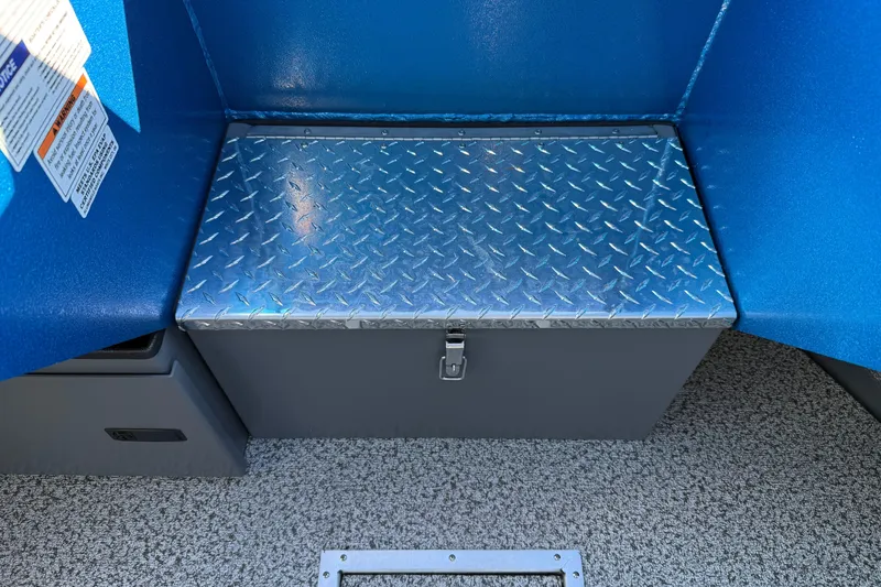 Slide: The Image of 2026 Alumaweld Intruder Outboard 22 interior storage compartment with open door. - 33