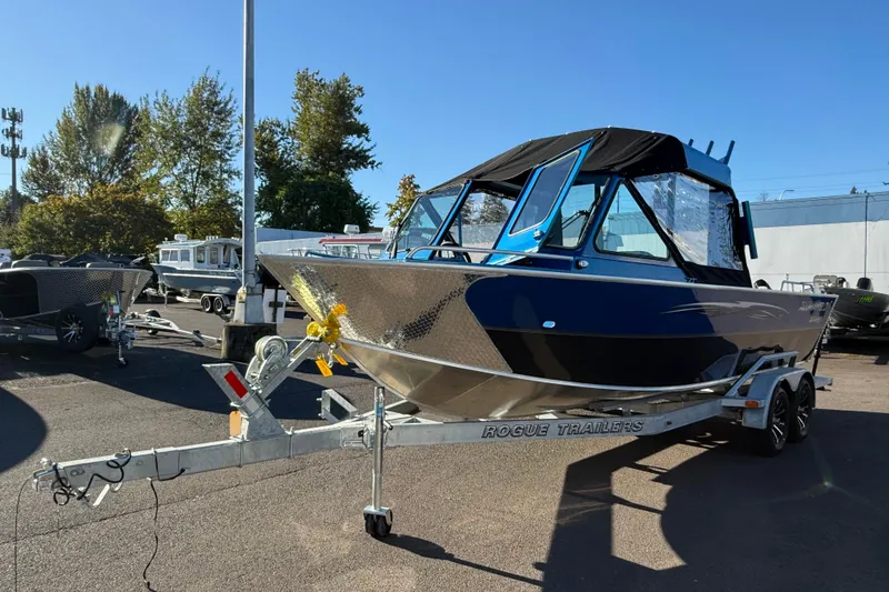 Slide: The Image of 2026 Alumaweld Intruder Outboard 22 boat on trailer, parked outdoors. - 4