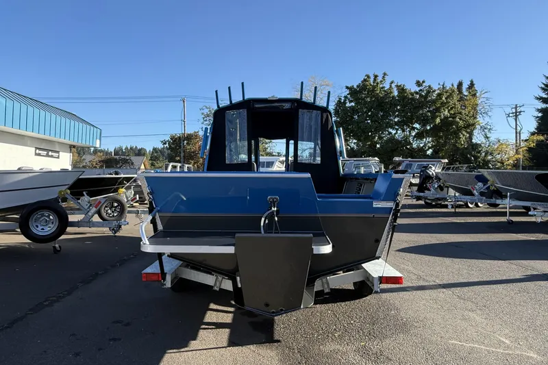 Slide: The Image of 2026 Alumaweld Intruder Outboard 22 boat on trailer at Stevens Marine dealership. - 5