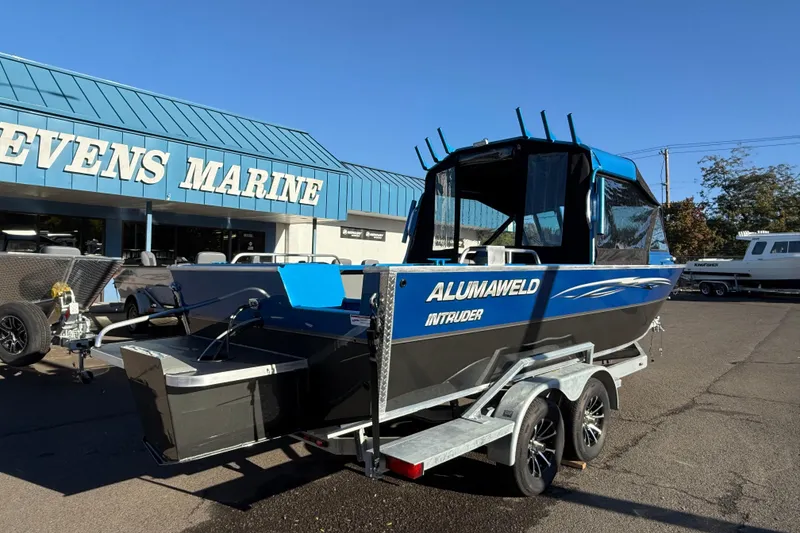 Slide: The Image of 2026 Alumaweld Intruder Outboard 22 boat interior with blue accents and seating. - 6