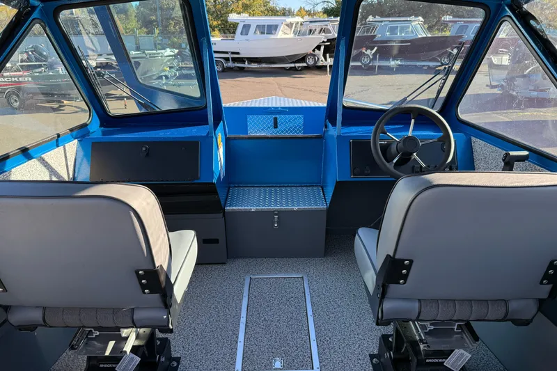 Slide: The Image of Interior view of 2026 Alumaweld Intruder Outboard 22 boat with dual seating and steering wheel. - 10