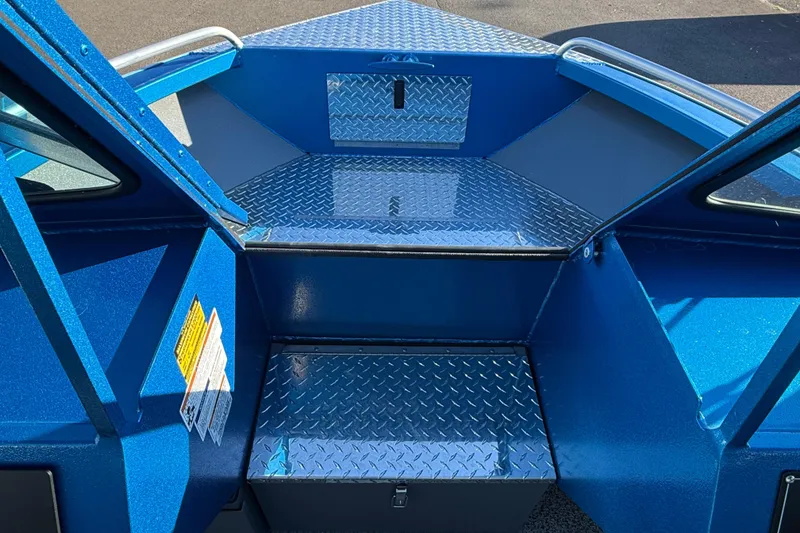 Slide: The Image of 2026 Alumaweld Intruder Outboard 22 boat interior with blue diamond plate flooring. - 13