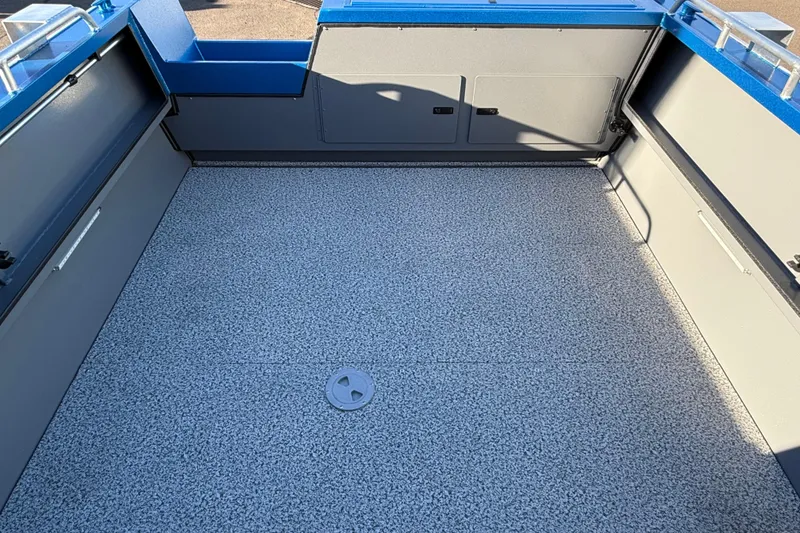 Slide: The Image of 2026 Alumaweld Intruder Outboard 22 boat interior with spacious, textured flooring and storage compartments. - 18