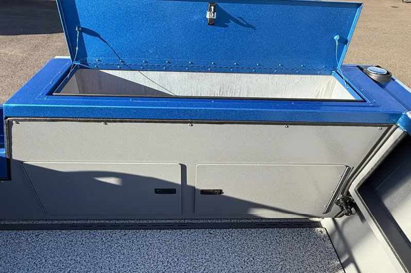 Slide: The Image of 2026 Alumaweld Intruder Outboard 22 boat storage compartment with blue lid open. - 20