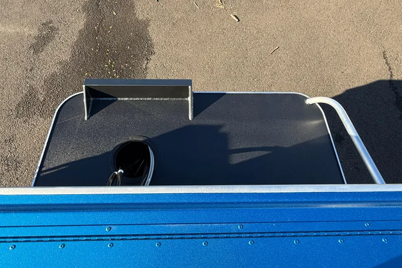 Slide: The Image of 2026 Alumaweld Intruder Outboard 22 boat deck, featuring sleek blue and black design. - 26