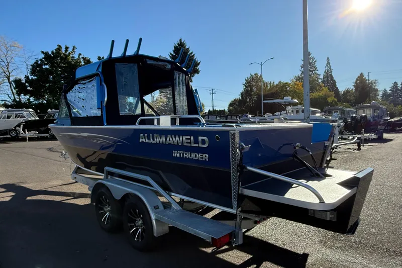 Slide: The Image of 2026 Alumaweld Intruder Outboard 22 boat on trailer in sunny outdoor setting. - 3
