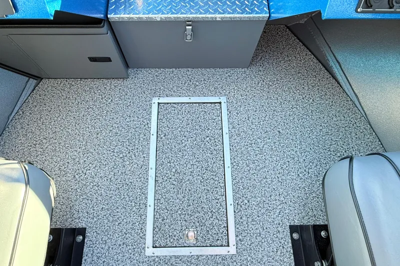 Slide: The Image of 2026 Alumaweld Intruder Outboard 22 interior with textured flooring and storage compartment. - 31