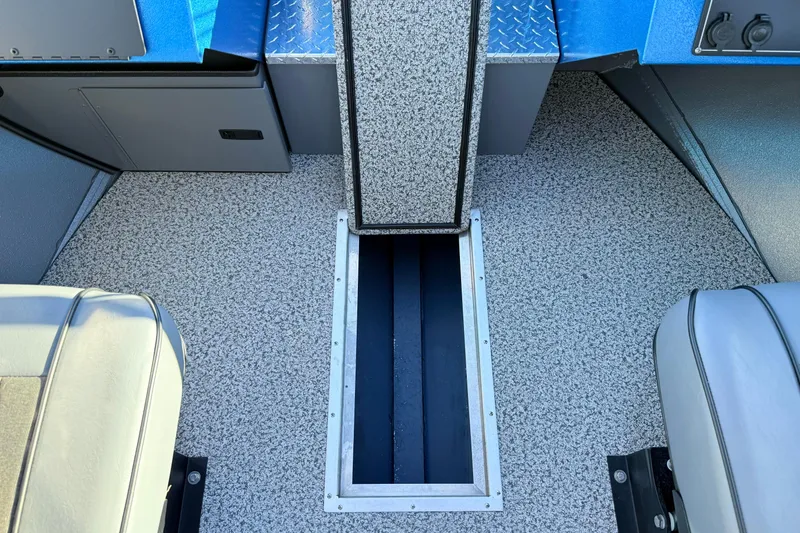 Slide: The Image of 2026 Alumaweld Intruder Outboard 22 boat interior with storage compartment and seating. - 32