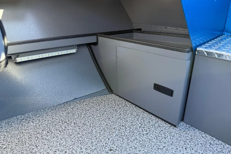 Slide: The Image of Interior of 2026 Alumaweld Intruder Outboard 22 boat, featuring storage compartment and LED lighting. - 35