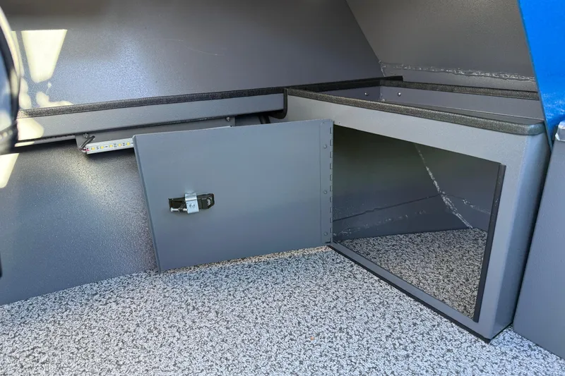 Slide: The Image of 2026 Alumaweld Intruder Outboard 22 interior storage compartment with open door. - 36