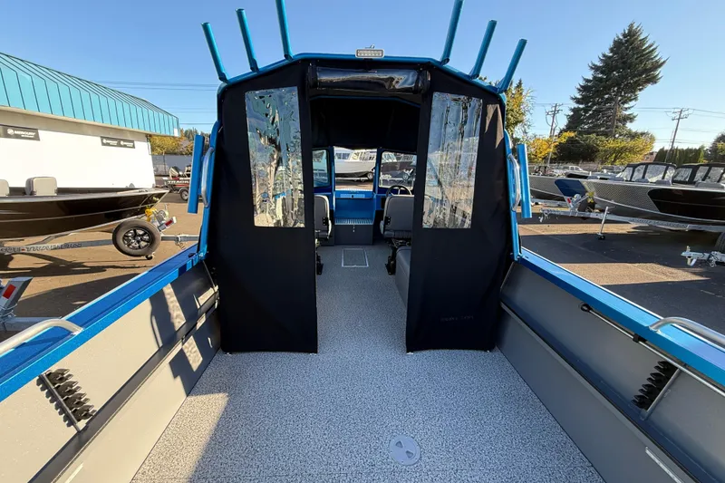 Slide: The Image of 2026 Alumaweld Intruder Outboard 22 boat interior with blue accents and seating. - 8