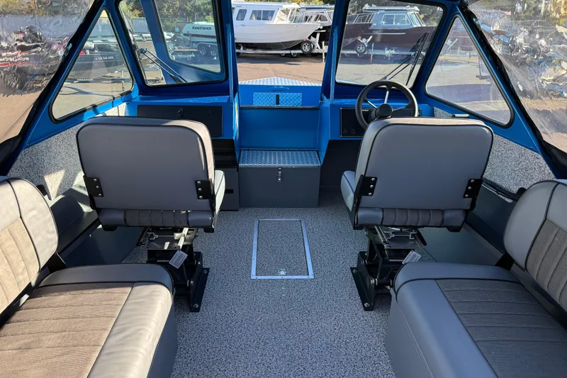 Slide: The Image of Interior of 2026 Alumaweld Intruder Outboard 22 boat with seating and steering wheel. - 9