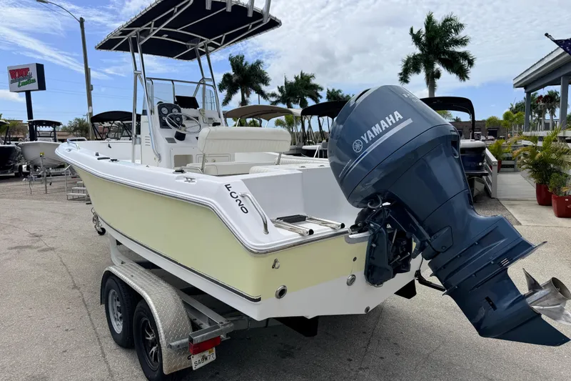 Slide: The Image of 2007 Sea Hunt Triton 220 boat with Yamaha outboard motor on trailer, parked outdoors. - 6